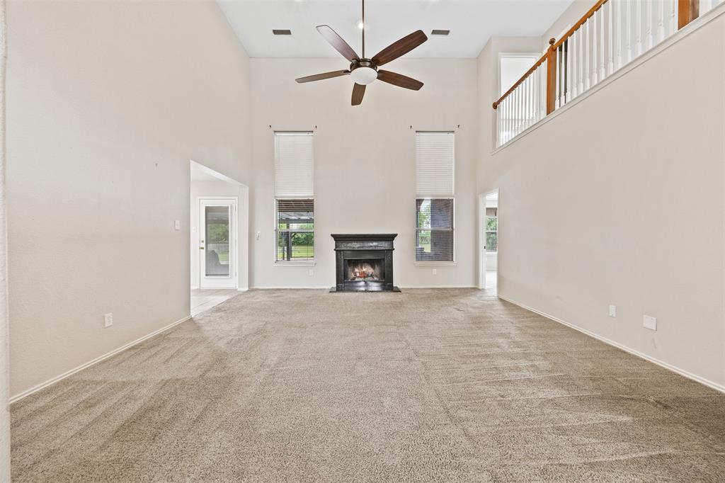 3931 Alpha Way Midlothian, TX 76065 - Photo 9 of 33 a view of a livingroom with a fireplace and a chandelier fan