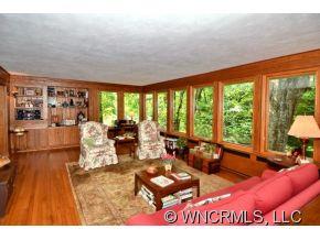 135 Doubleday Road Tryon, NC 28782 - Photo 2 of 12 a living room with furniture and large windows