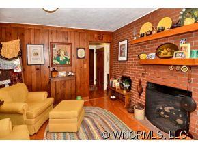 135 Doubleday Road Tryon, NC 28782 - Photo 6 of 12 a living room with furniture a flat screen tv and a fireplace