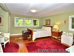 135 Doubleday Road Tryon, NC 28782 - Photo 9 of 12 a bedroom with a bed and wooden floor
