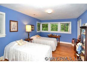 135 Doubleday Road Tryon, NC 28782 - Photo 10 of 12 a bedroom with two beds and a large window