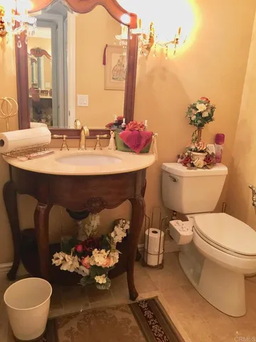a bathroom with a sink mirror and toilet