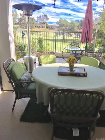 a dining room with furniture and a floor to ceiling window