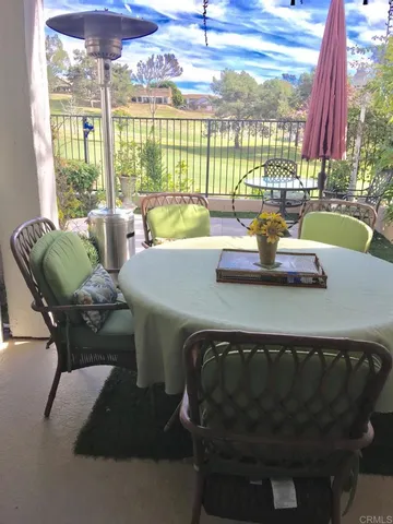 a dining room with furniture and a floor to ceiling window