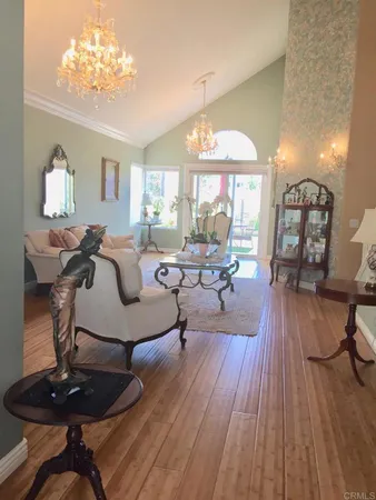 a living room with furniture and a chandelier