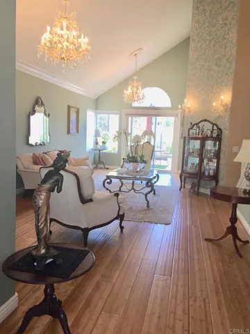 a living room with furniture and a chandelier