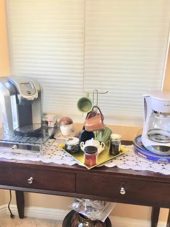 a sink and a stove with two chair