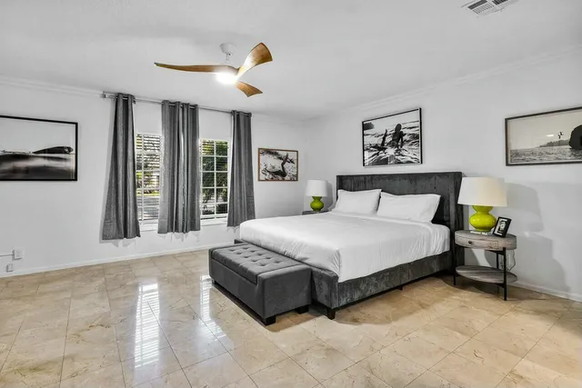 a view of a dining room with furniture water view and a floor to ceiling window