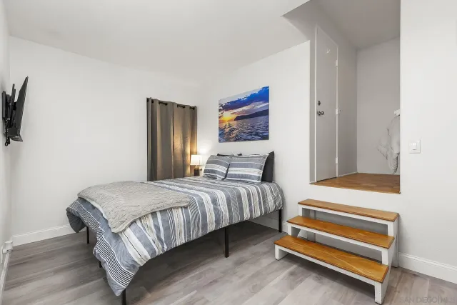 a bedroom with a bed and a chandelier