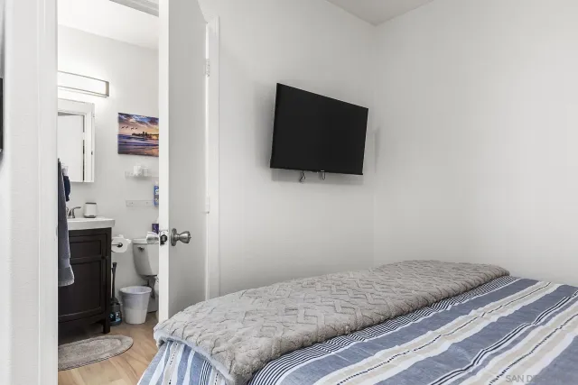 a bedroom with a bed and a flat screen tv