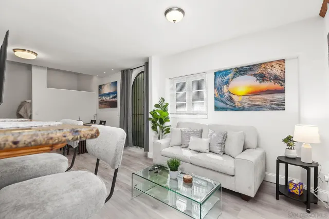 a living room with furniture and wall paintings