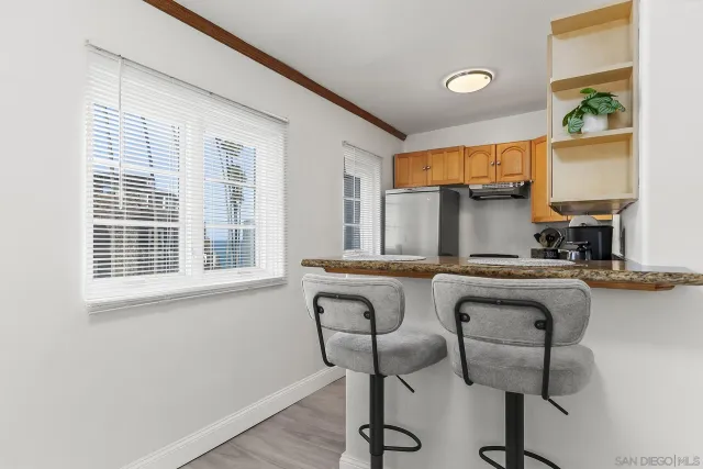 a kitchen with a table chairs and window