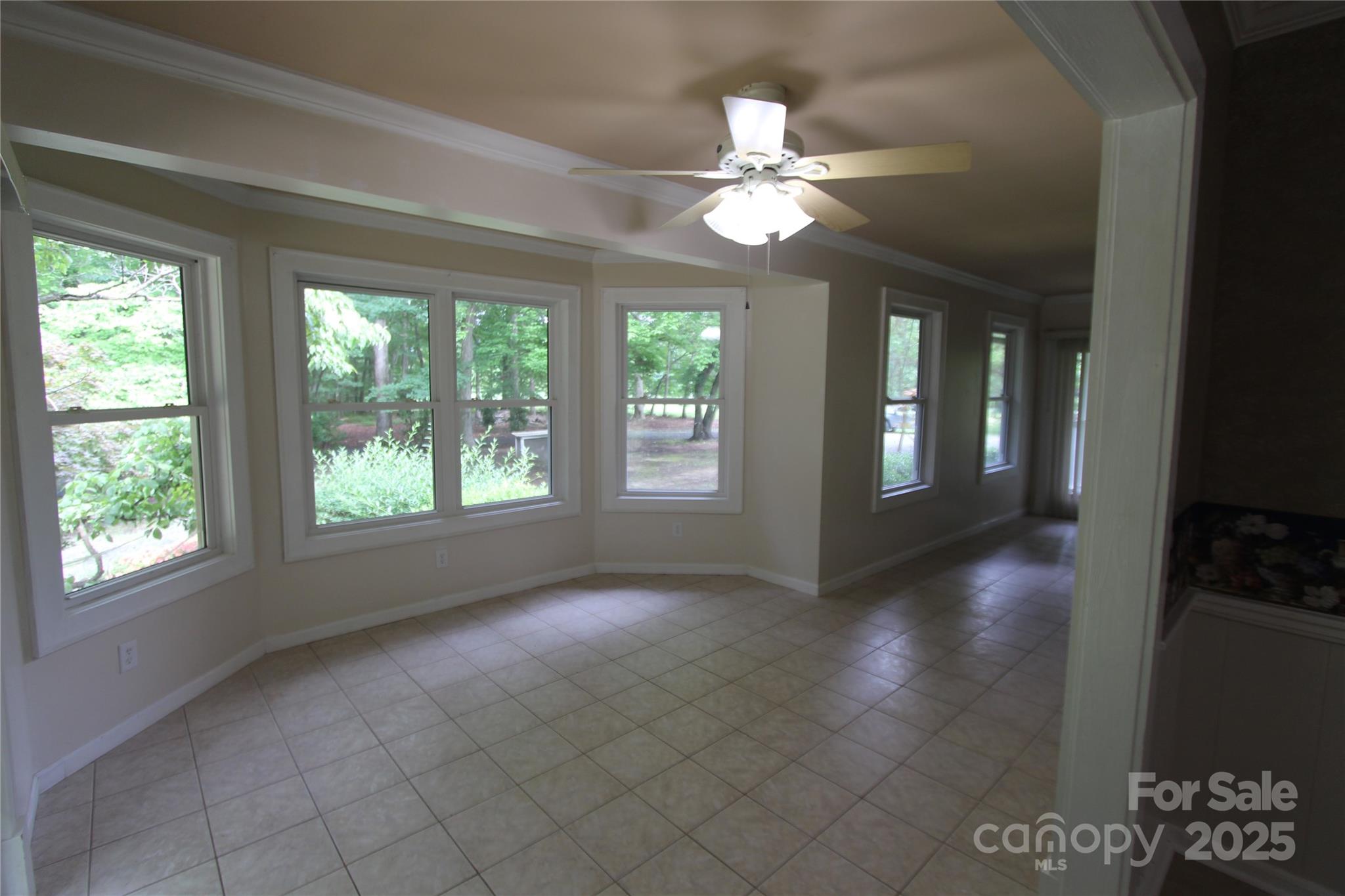 344 Lucas Road Star, NC 27356 - Photo 18 of 32 a view of an empty room with window and chandelier fan