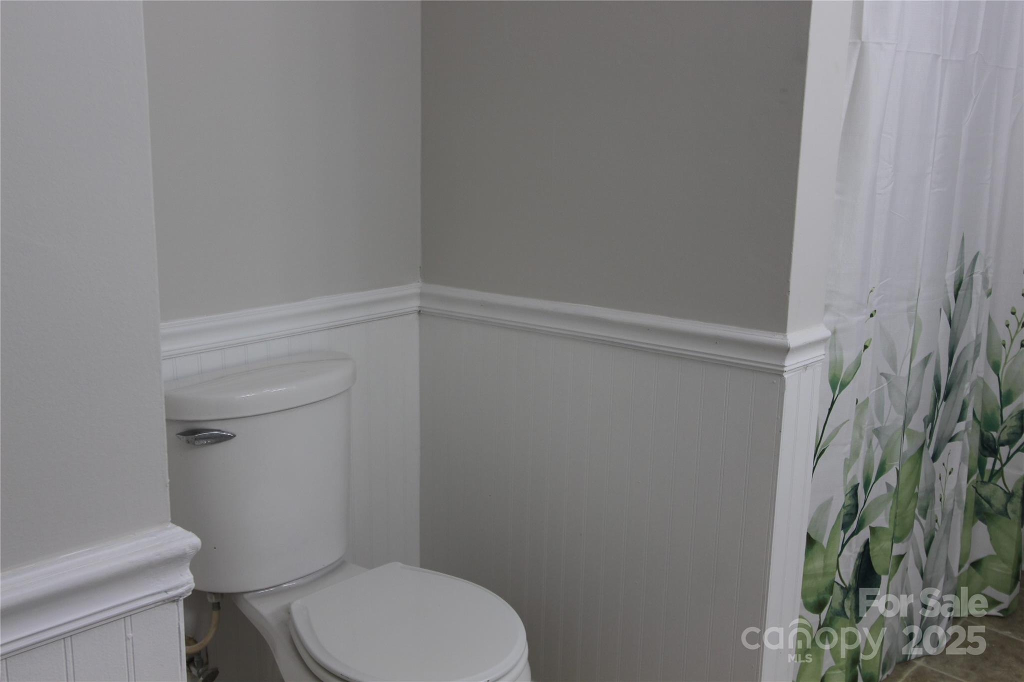 344 Lucas Road Star, NC 27356 - Photo 27 of 32 a white toilet sitting next to a shower curtain