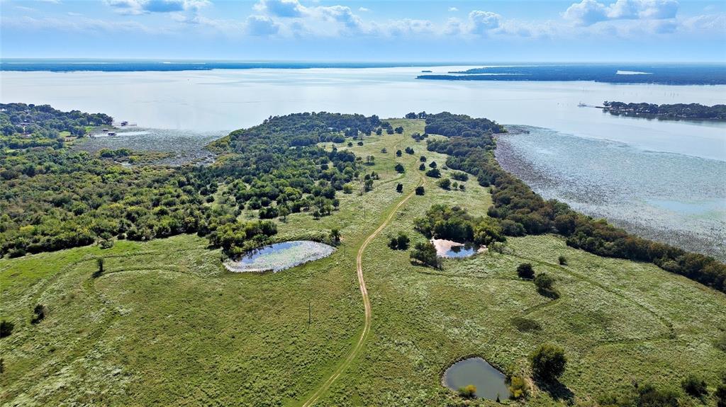 3410 Tbd County Road Lone Oak, TX 75453 - Photo 7 of 30 a view of a lake with a mountain in the background