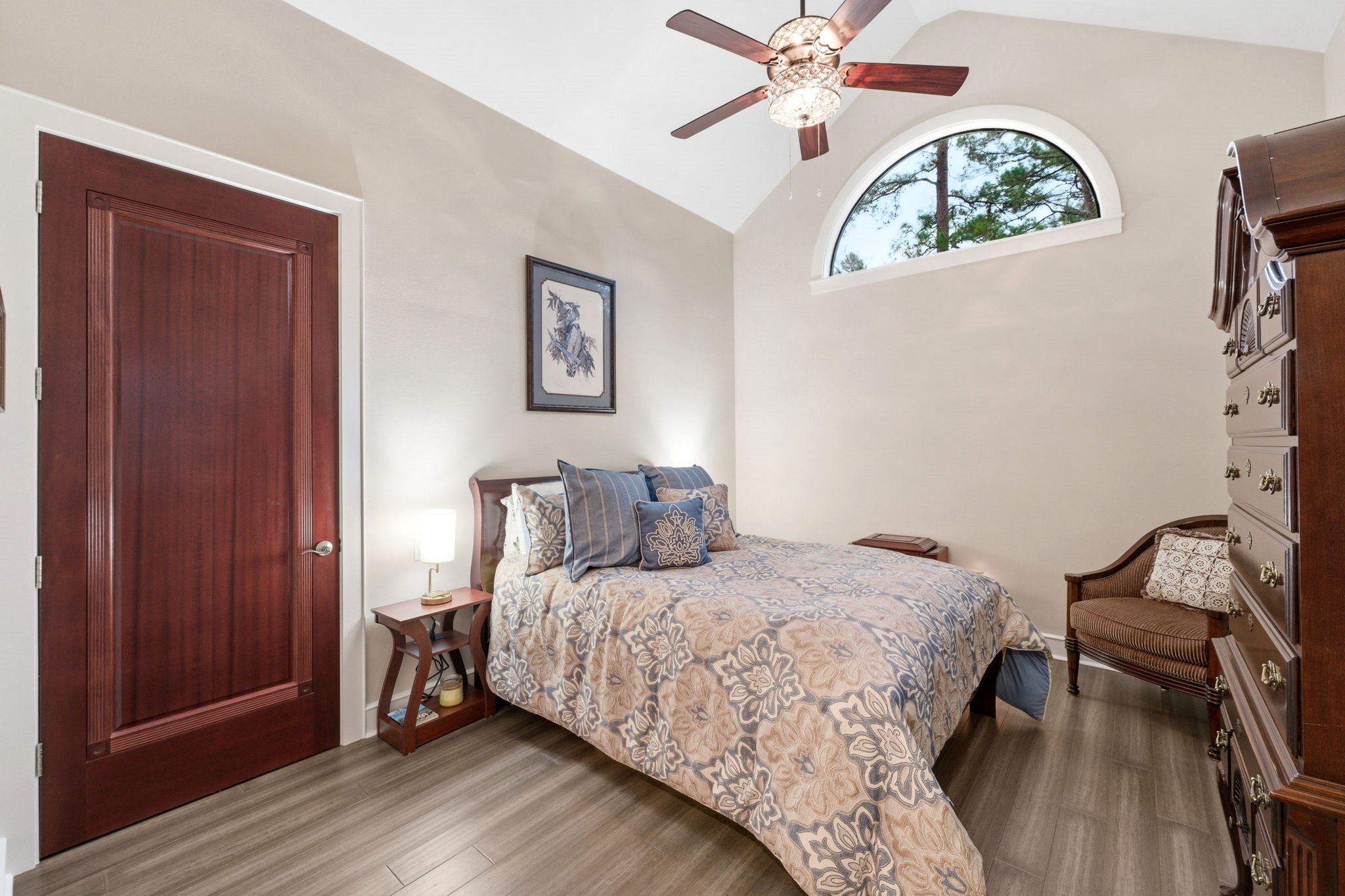 280 Sundog Road Huntsville, TX 77340 - Photo 27 of 50 Downstairs guest bedroom featuring hickory wood floors, vaulted ceiling, ceiling fan, and a walk-in closet.