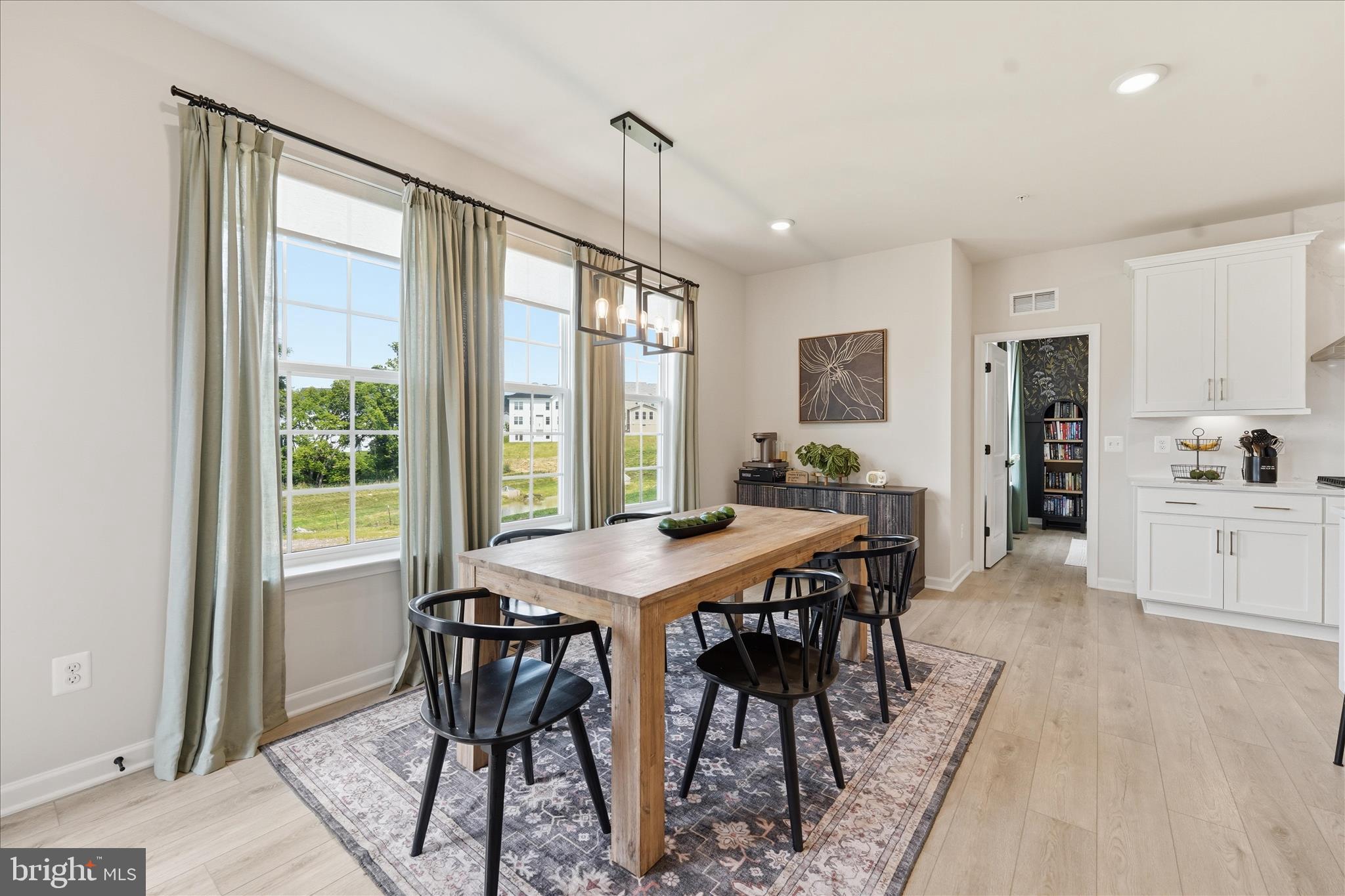 910 Enfield Farm Lane Brunswick, MD 21716 - Photo 22 of 87 a view of a dining room with furniture window and wooden floor