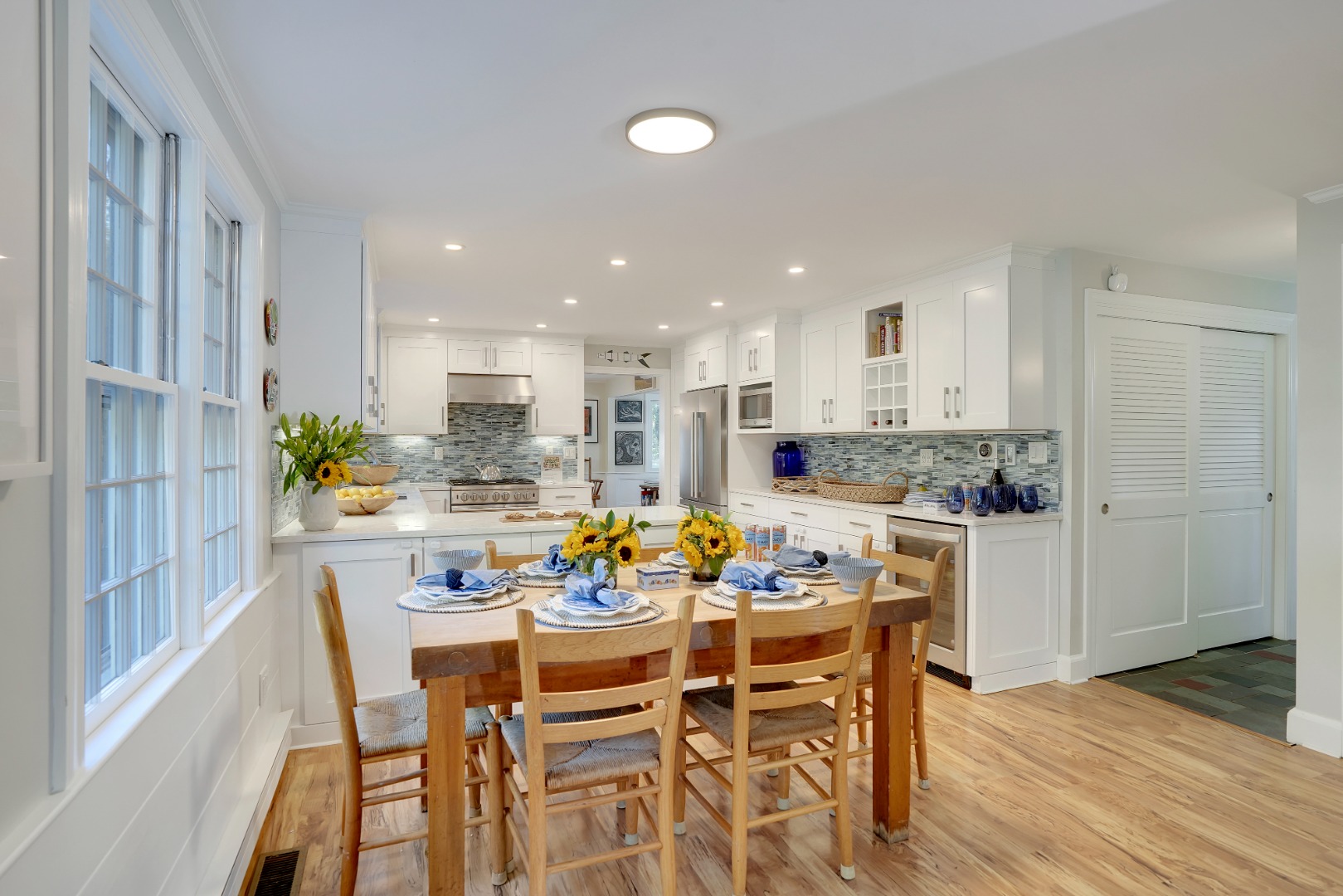28 Pine Tree Lane Vineyard Haven, MA 02568 - Photo 20 of 61 a kitchen with a dining table chairs and white appliances