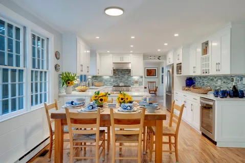 a kitchen that has a lot of cabinets a sink and a stove in it
