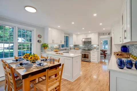 a dining room with furniture a window and a kitchen view