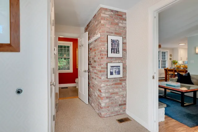 a living room with furniture a rug and a window