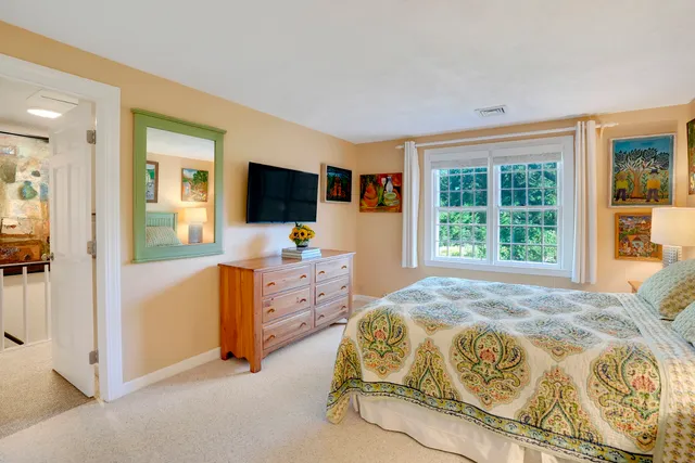 a bedroom with a bed and lamp