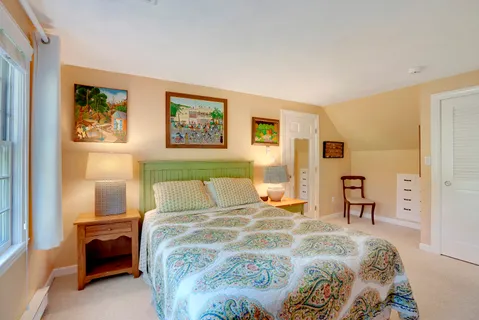 a bathroom with a granite countertop toilet sink and window