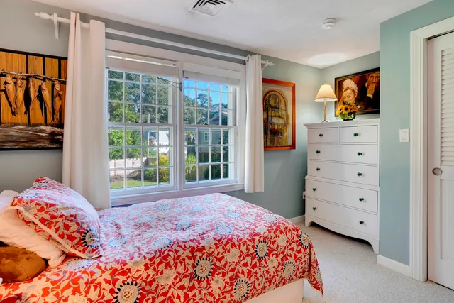 a bedroom with a large bed and a window