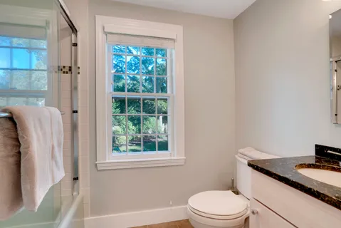 a bathroom with a double vanity sink mirror and shower