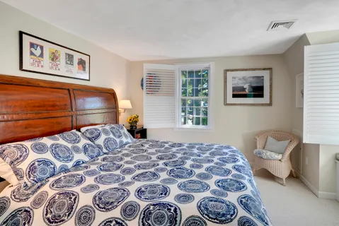 a bedroom with a bed and flat screen tv