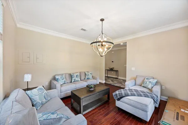 a living room with furniture a ceiling fan and a window