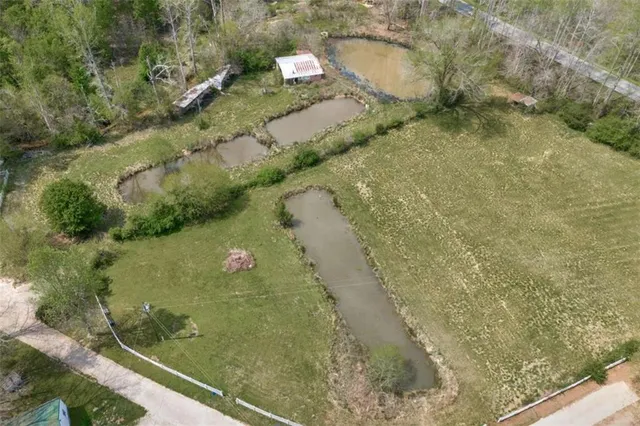 a view of a small house with a yard