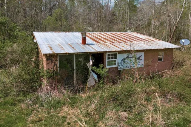 a view of a house with a yard chairs and a table