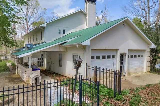 a view of a house with wooden fence