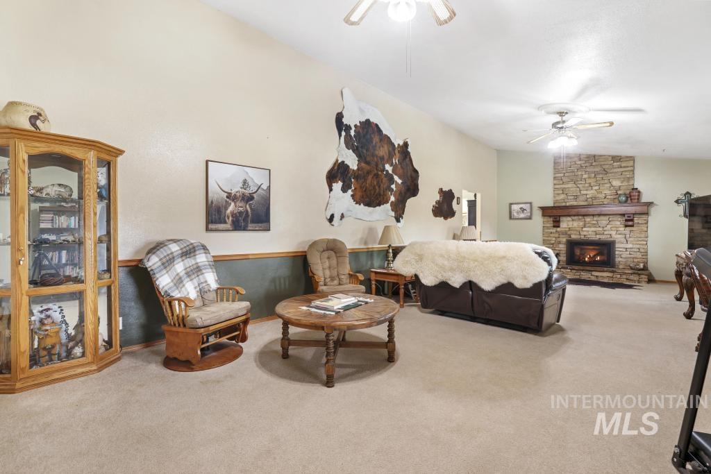 213 Sage Road West Jerome, ID 83338 - Photo 20 of 50 carpet flooring, ceiling fan, lofted ceiling, and a fireplace