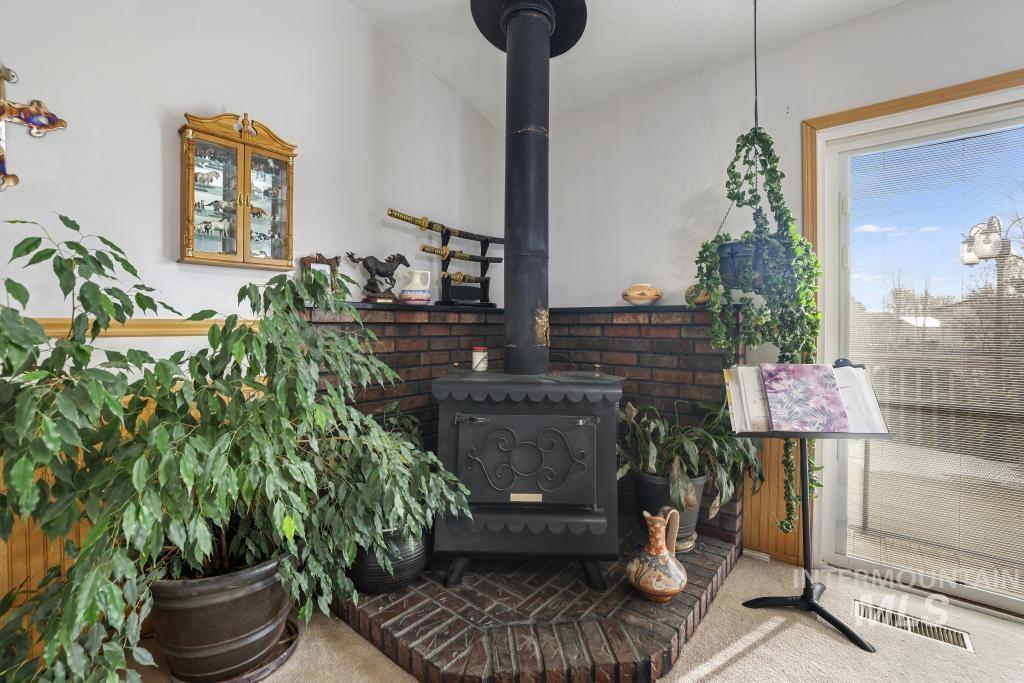 213 Sage Road West Jerome, ID 83338 - Photo 26 of 50 Detailed view of a wood stove and carpet