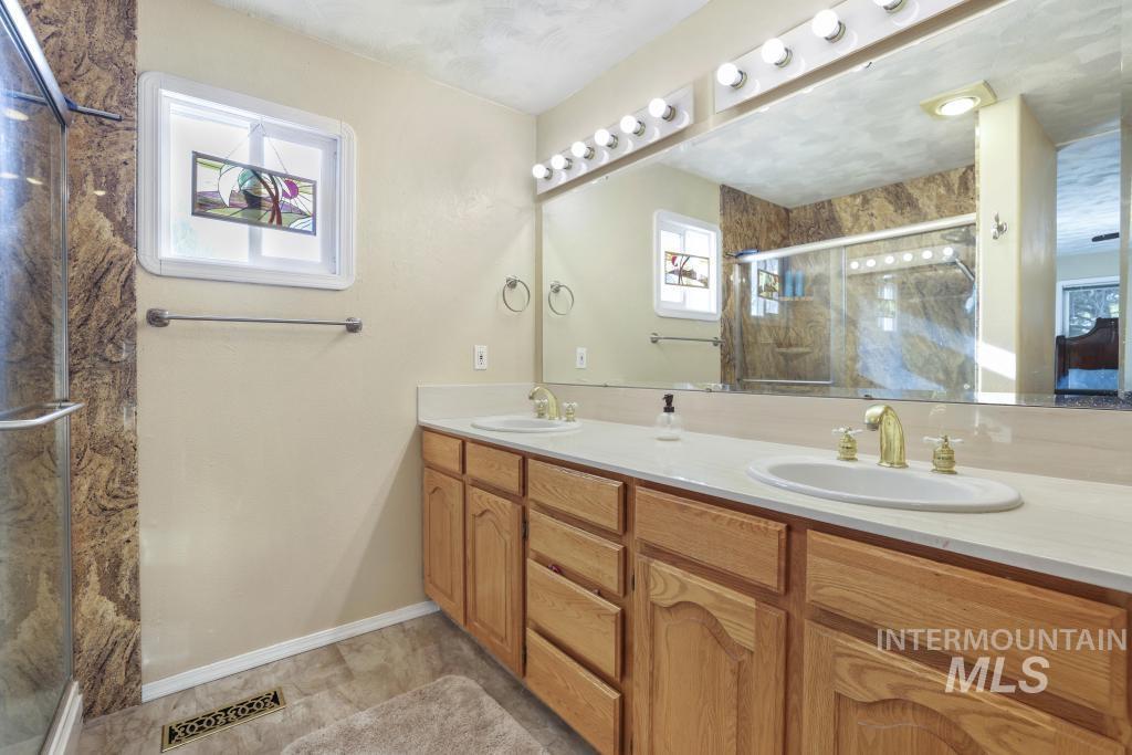 213 Sage Road West Jerome, ID 83338 - Photo 31 of 50 Full bathroom with a stall shower and double vanity