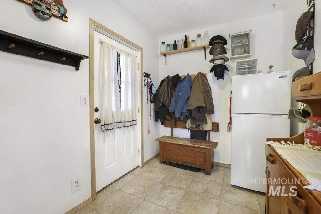 213 Sage Road West Jerome, ID 83338 - Photo 37 of 50 Mudroom with baseboards and light tile patterned floors
