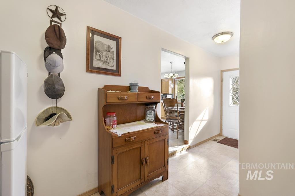 213 Sage Road West Jerome, ID 83338 - Photo 38 of 50 Corridor with baseboards and a chandelier