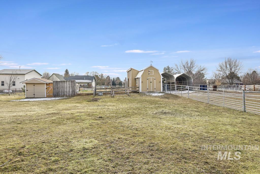 213 Sage Road West Jerome, ID 83338 - Photo 4 of 50 View of yard with an outdoor barn, shed, fenced irrigated pasture and an exterior structure