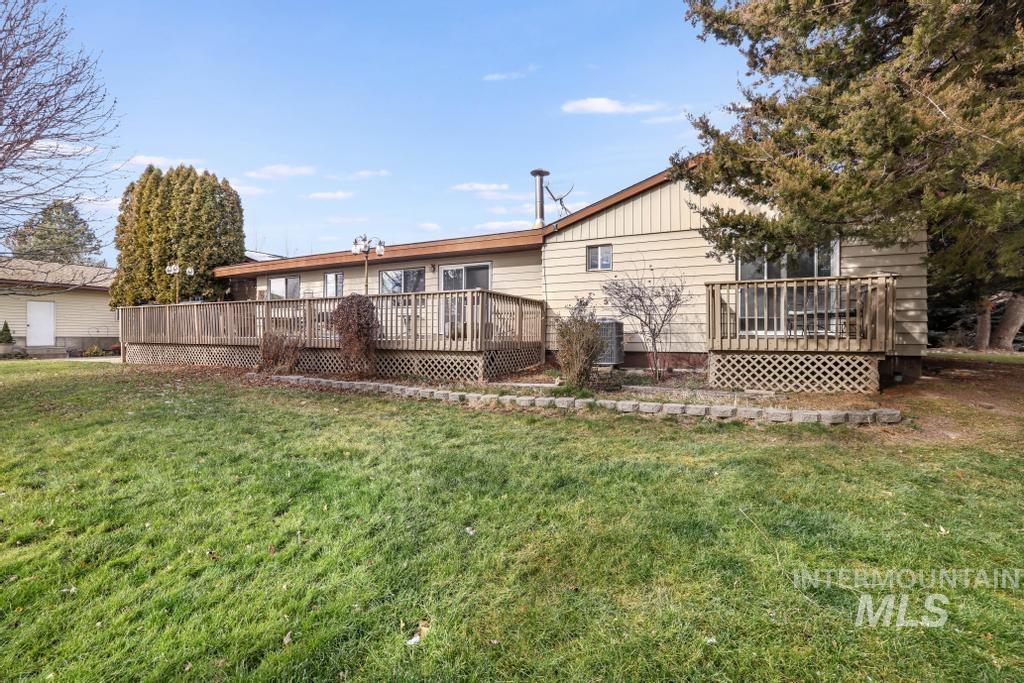 213 Sage Road West Jerome, ID 83338 - Photo 41 of 50 Rear view of house with a deck and a yard