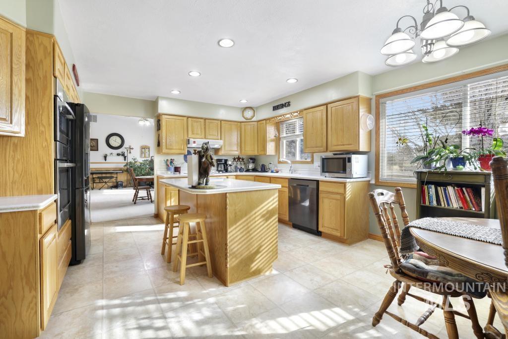 213 Sage Road West Jerome, ID 83338 - Photo 9 of 50 Kitchen featuring light countertops, a kitchen breakfast bar, a kitchen island, recessed lighting, and appliances with stainless steel finishes