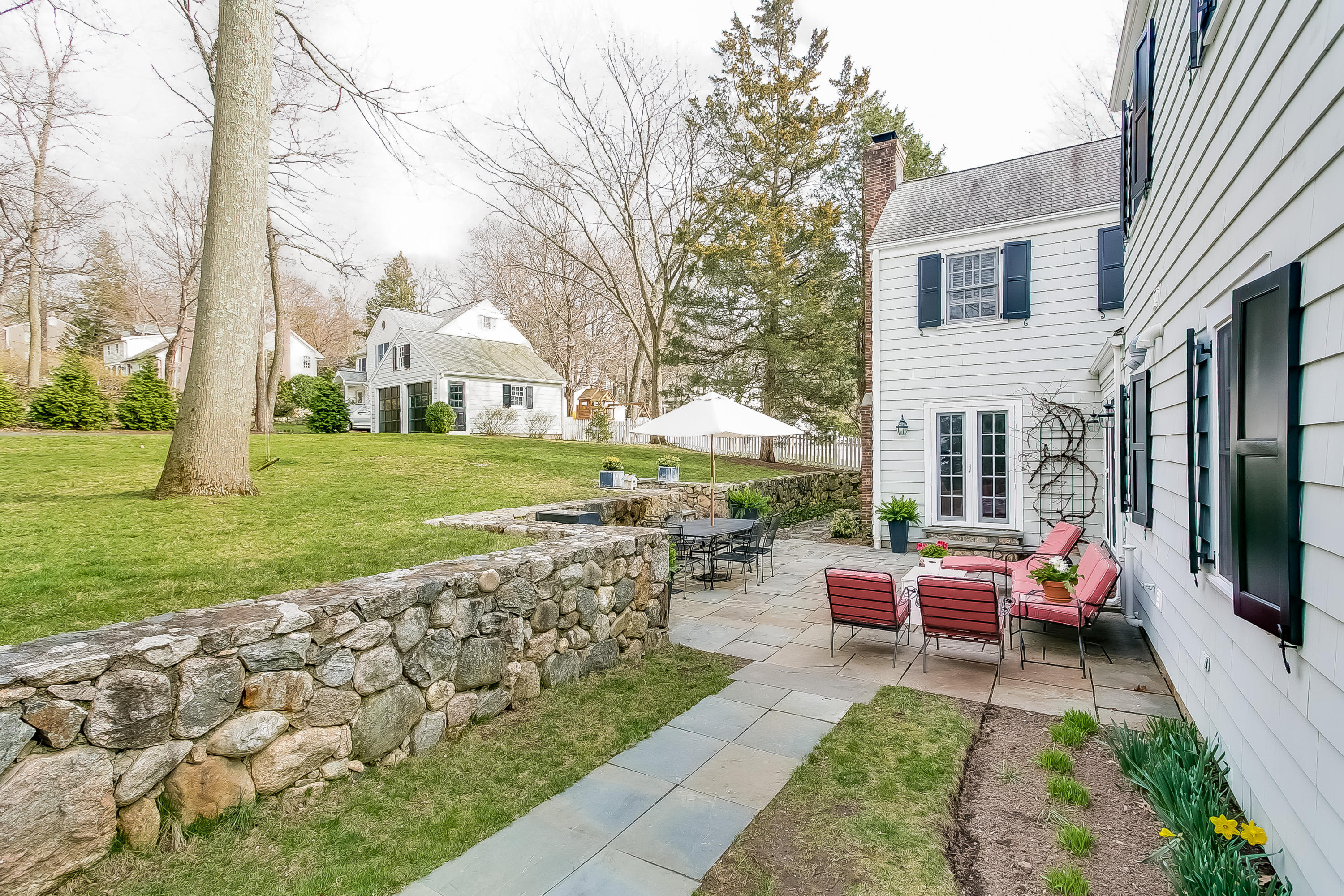 2 Miller Road Darien, CT 06820 - Photo 24 of 28 a view of a house with backyard sitting area and garden