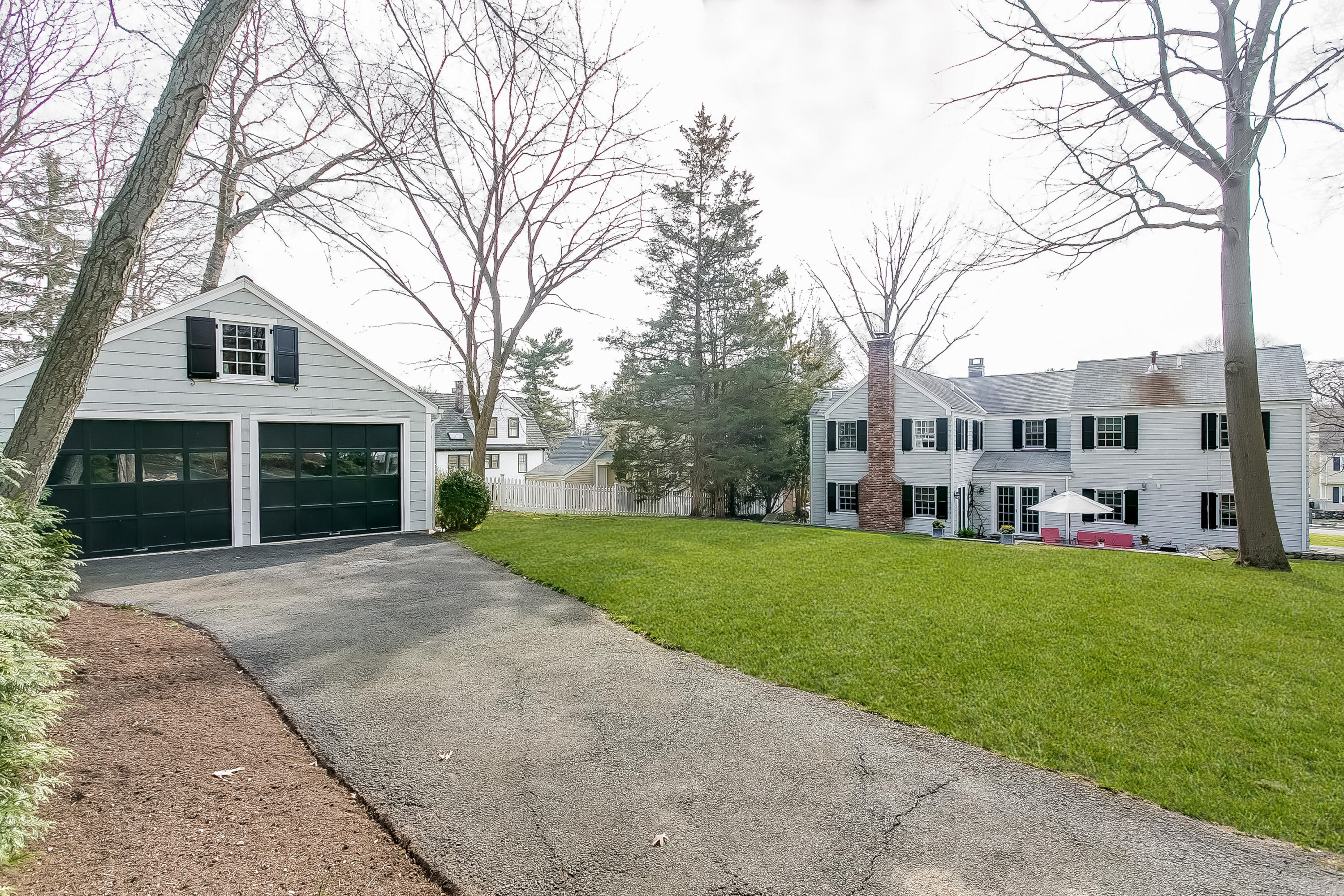 2 Miller Road Darien, CT 06820 - Photo 25 of 28 a front view of a house with a yard and garage