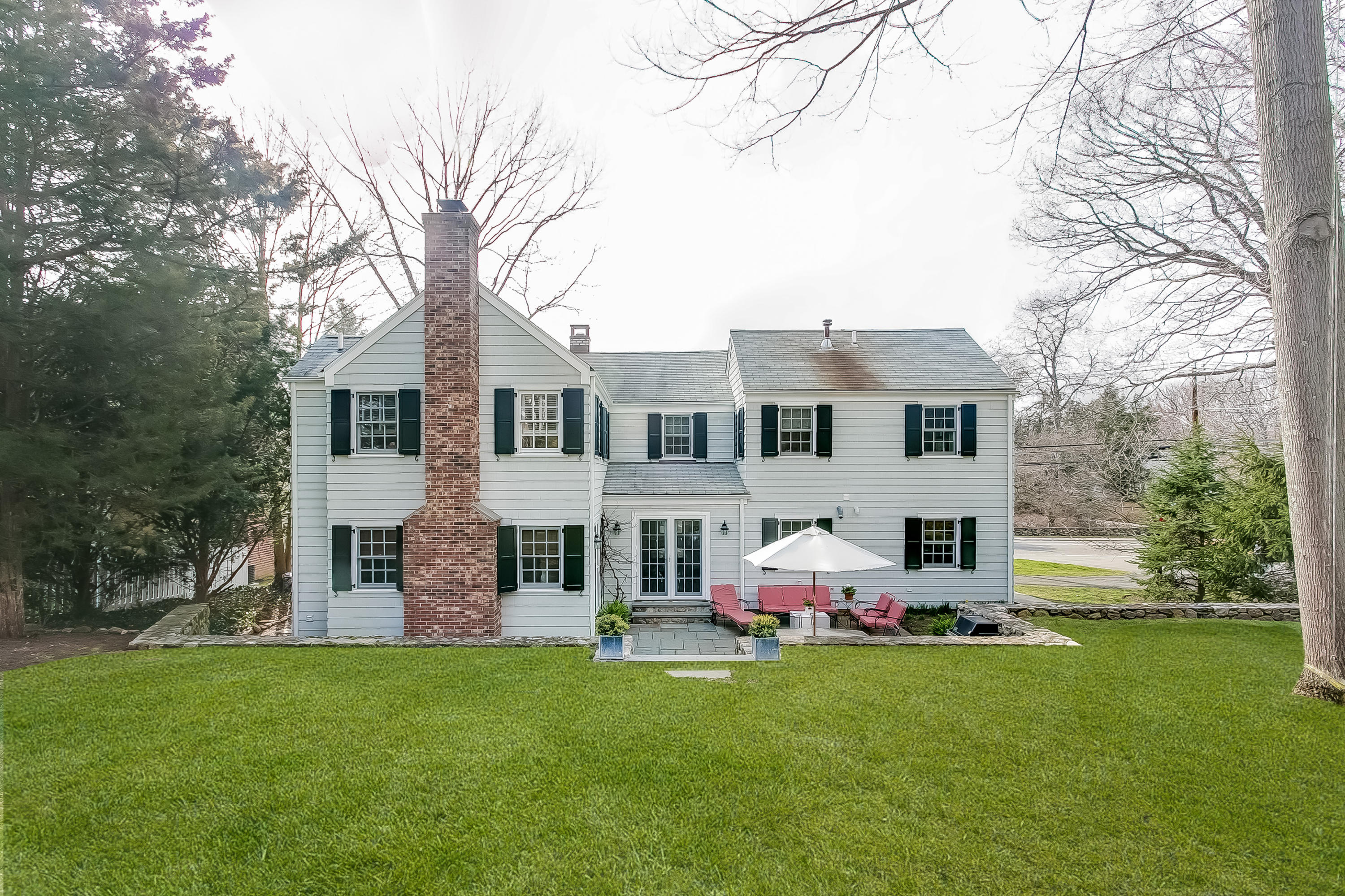 2 Miller Road Darien, CT 06820 - Photo 3 of 28 a front view of a house with a garden and trees