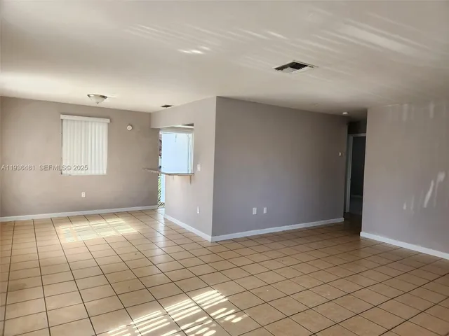 a view of an empty room and window