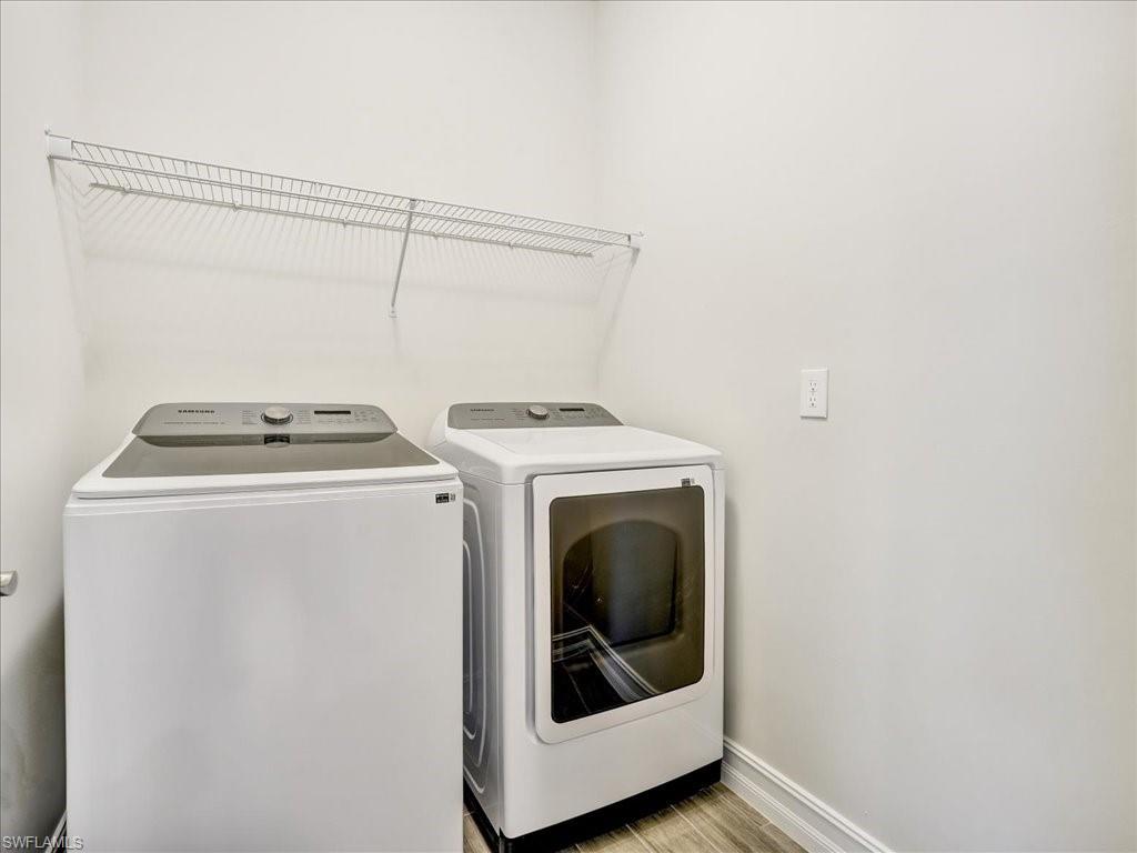 999 Enbrook Loop Naples, FL 34114 - Photo 11 of 50 a utility room with dryer and washer