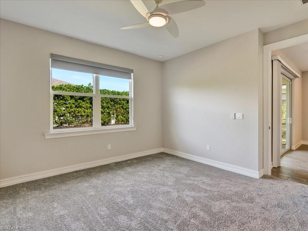 999 Enbrook Loop Naples, FL 34114 - Photo 21 of 50 an empty room with windows and closet