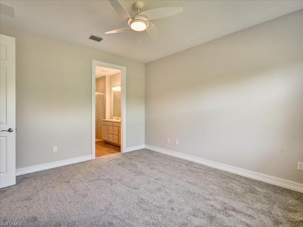 999 Enbrook Loop Naples, FL 34114 - Photo 23 of 50 an empty room with closet and windows