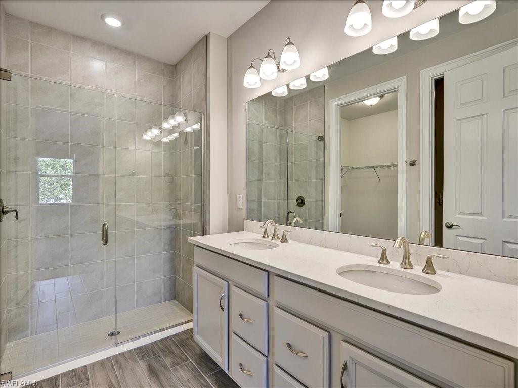999 Enbrook Loop Naples, FL 34114 - Photo 25 of 50 a bathroom with a sink double vanity and a mirror